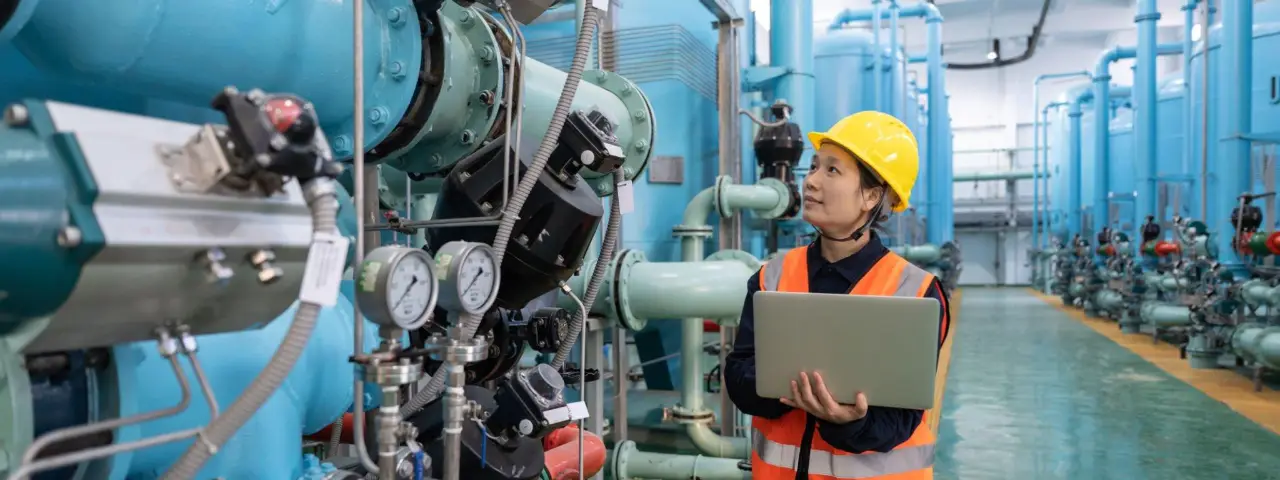 female worker inspecting in a chemical plant